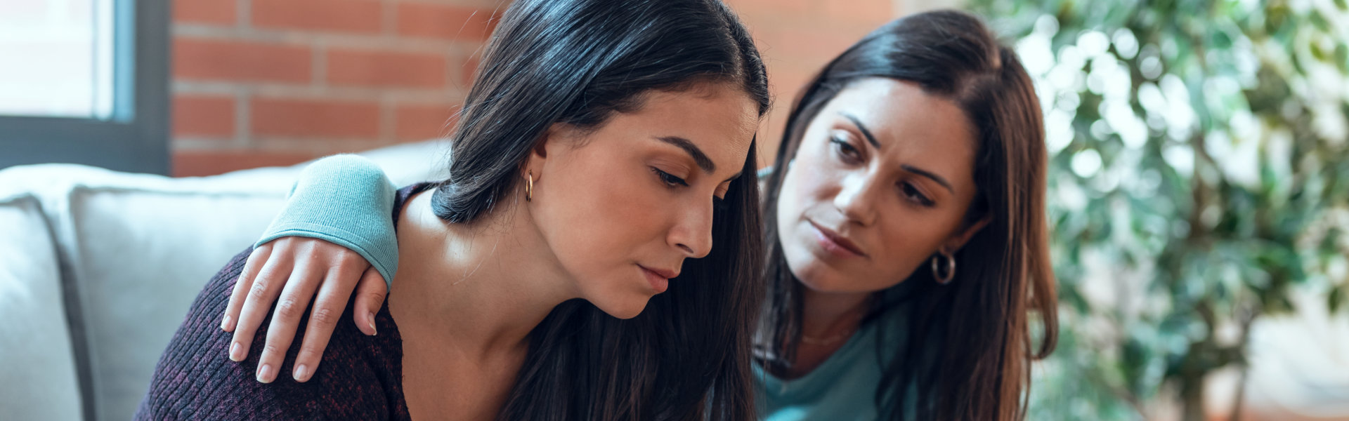 woman consoling another woman